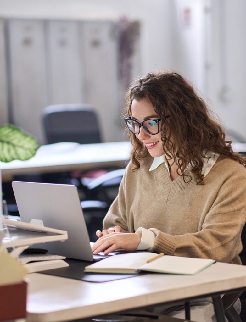 Young Happy Professional Business Woman Employee Sitting At Desk Working