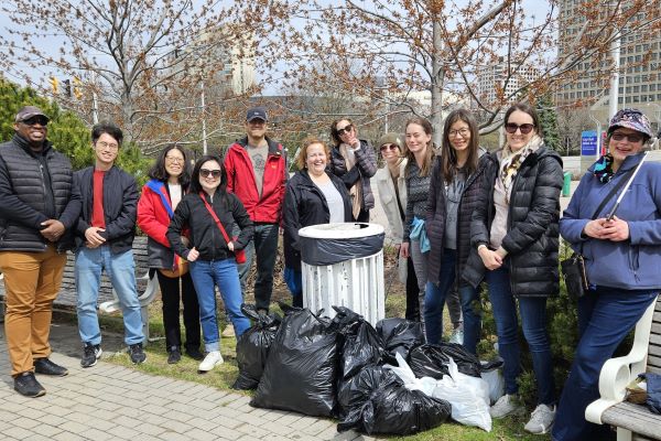 Tourism HR Canada staff gathered with garbage collecting tools.